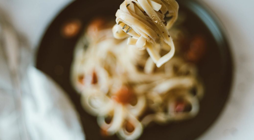 close up of noodles wrapped on a fork